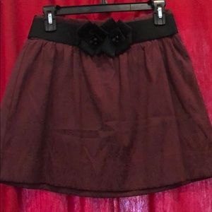 Cranberry mini skirt w/ black belt.